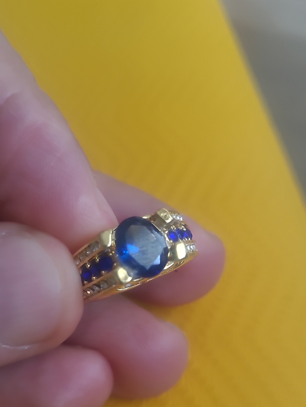 Gold Ring with Blue Center Stone and Accent Stones
